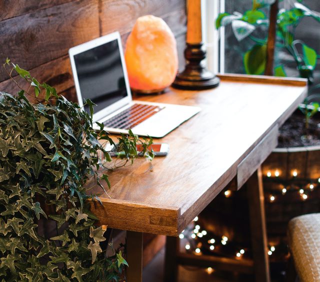 Himalayan Salt Lamp Near Laptop On Wooden Table